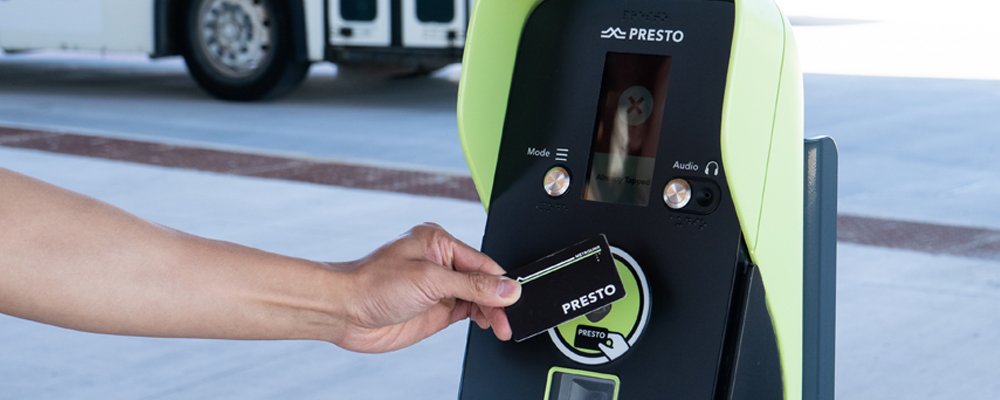 A transit rider tapping a PRESTO card on a PRESTO machine